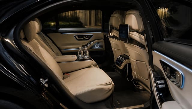 Cream leather rear cabin of a luxury sedan used for SJC airport transfers in San Jose, California